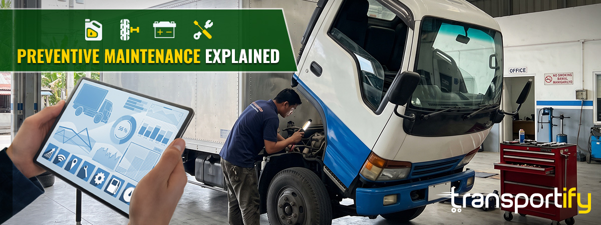 Technician inspecting truck engine using digital tablet for preventive maintenance.